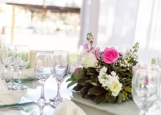 An elegant table setting adorned with a beautiful centerpiece of flowers.