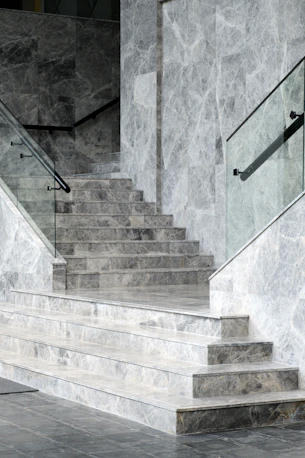 a stone staircase with a stone wall