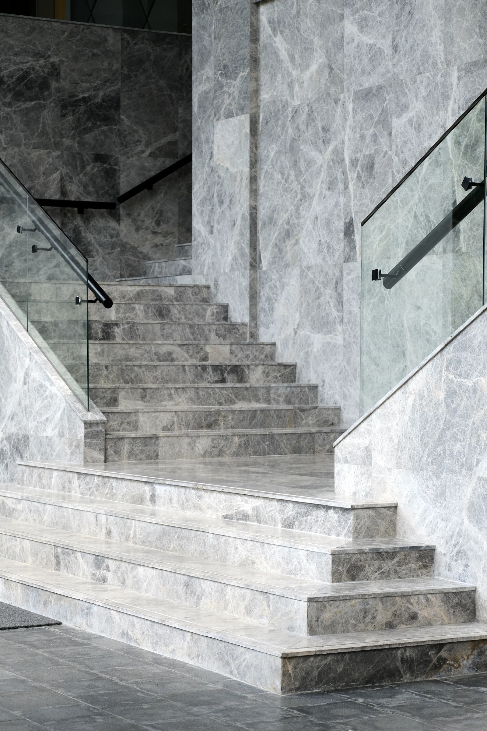 Stone-clad staircase alongside a textured feature wall