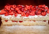 A layered vanilla sponge cake filled with whipped cream and fresh strawberries.