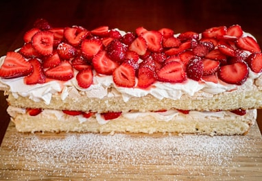 A light and fluffy vanilla sponge cake topped with whipped cream and delicate edible flowers.