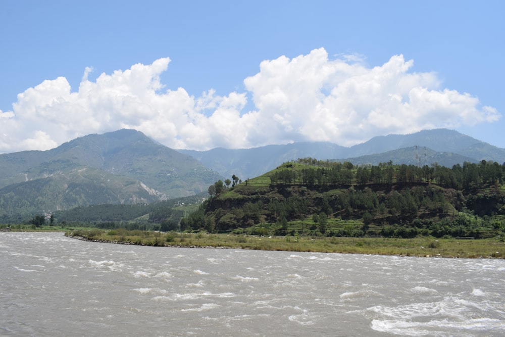 a river with mountains in the background