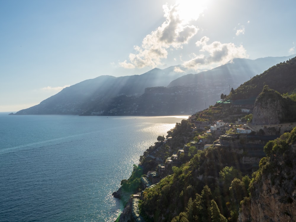 a body of water with trees and mountains around it