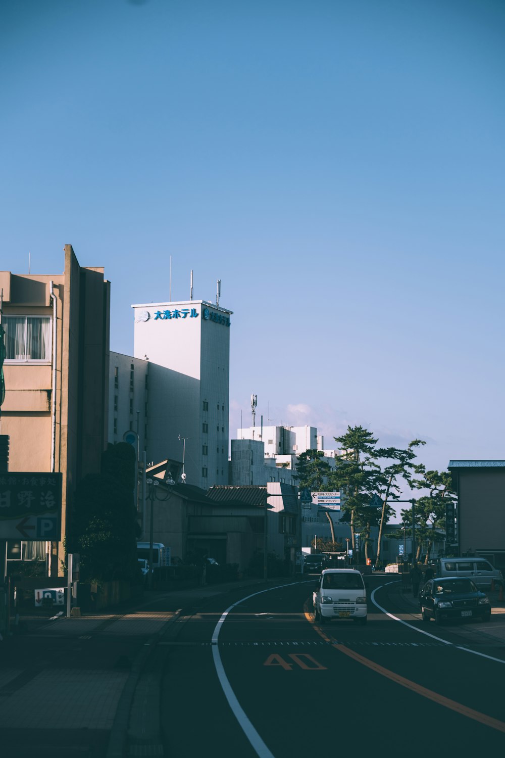 a street with cars and buildings on the side