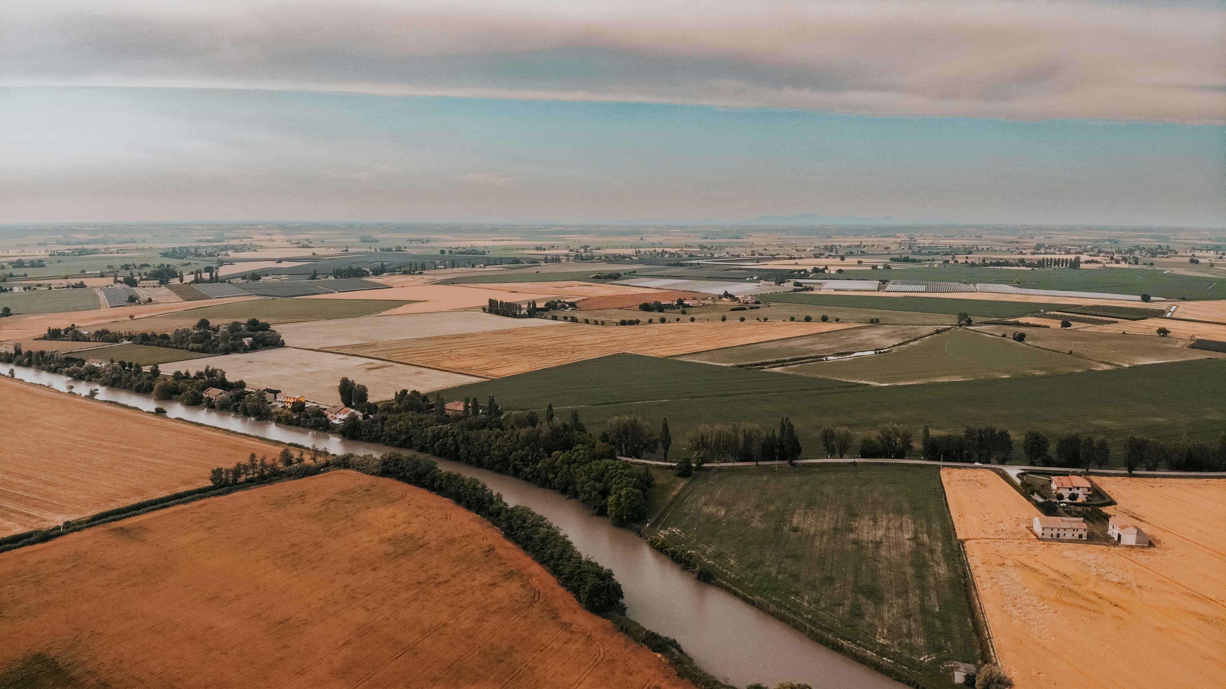 a landscape with fields and buildings