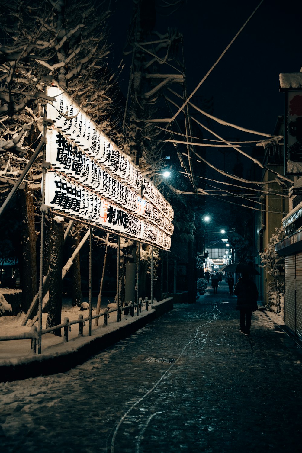 a person walking down a street with a sign on it