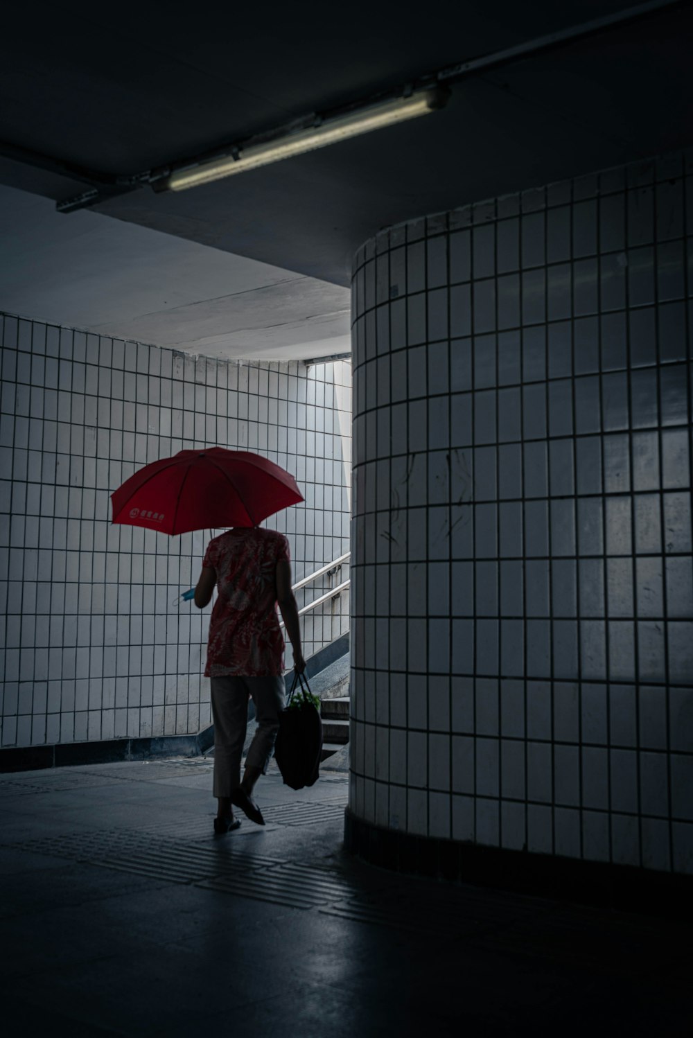 a woman walking with an umbrella