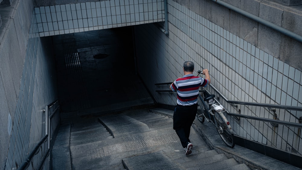 a person walking down a sidewalk next to a bike