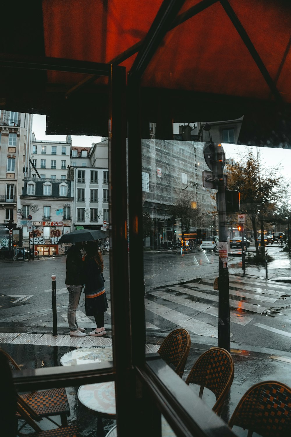 a person stands under an umbrella