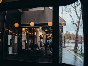 a group of people sitting at a table outside