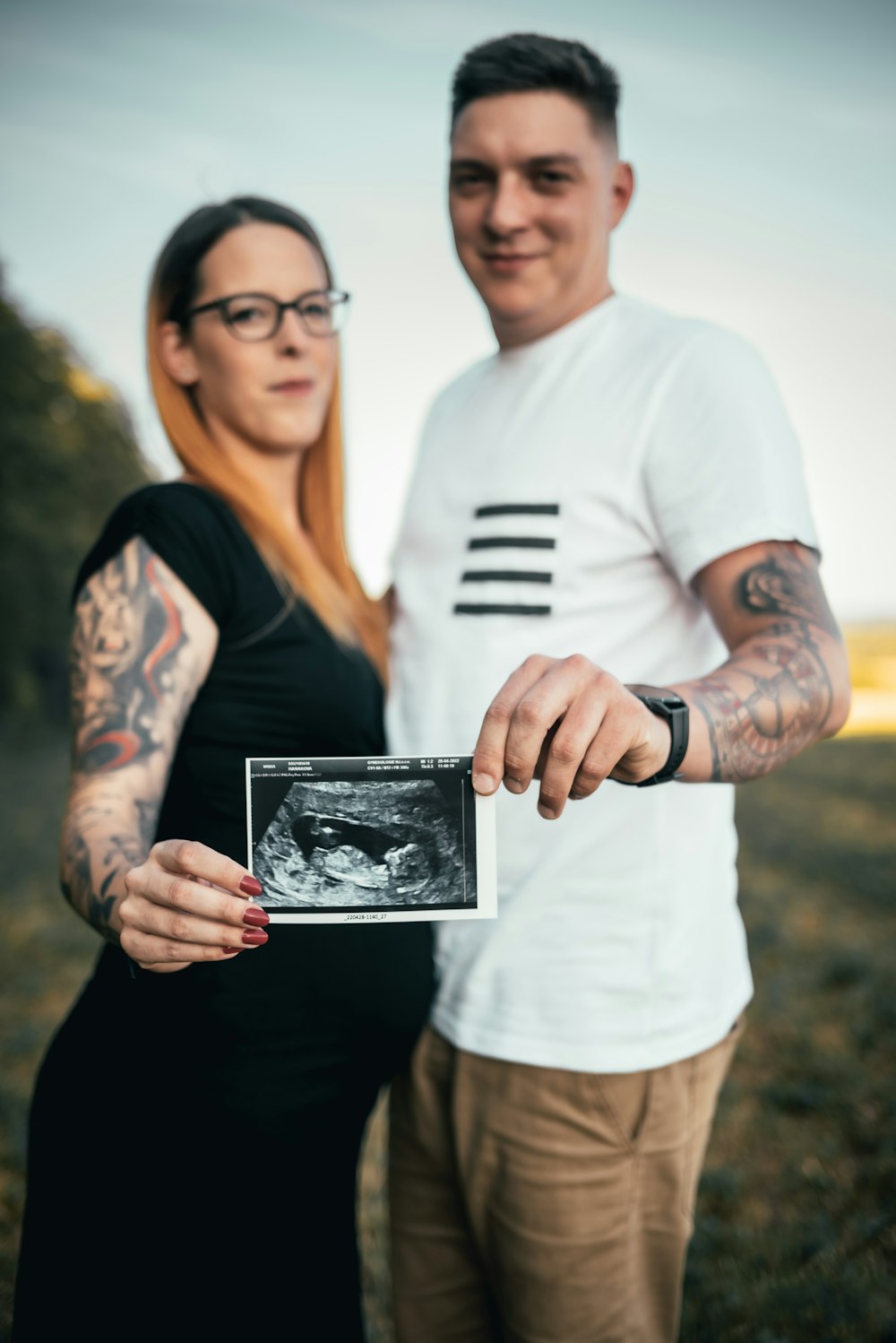 a man and woman holding a picture