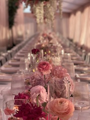 Elegant wedding table adorned with fresh flower centerpieces in soft pastel tones.
