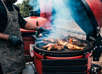 a person grilling meat on a grill