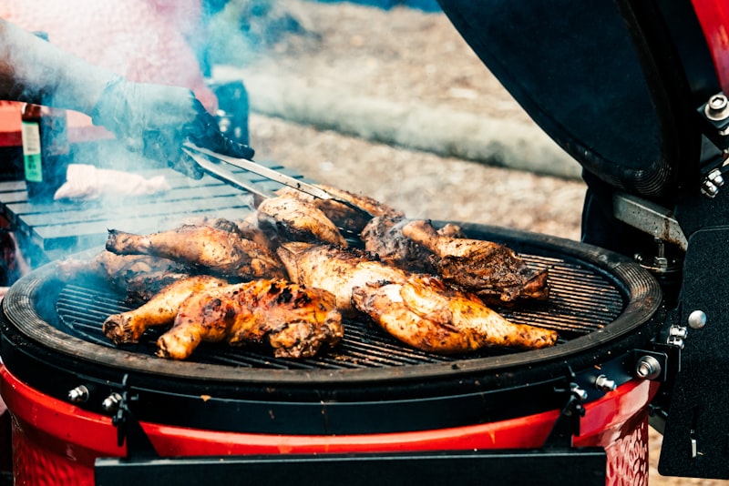 Jerk seasoned meat cooking over a smoky grill