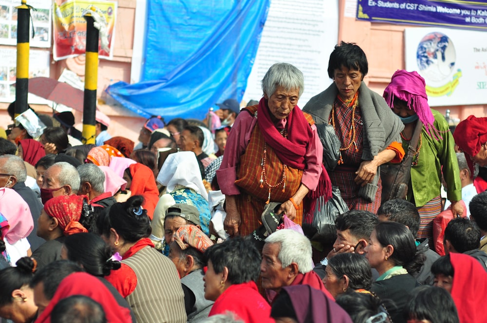 a man and woman talking to a crowd of people