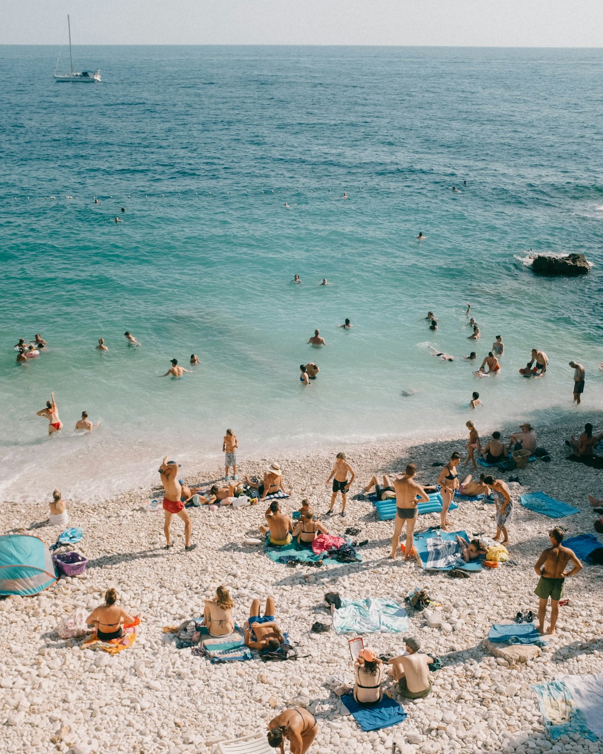 Turquoise shallows and a pebble beach seen from above