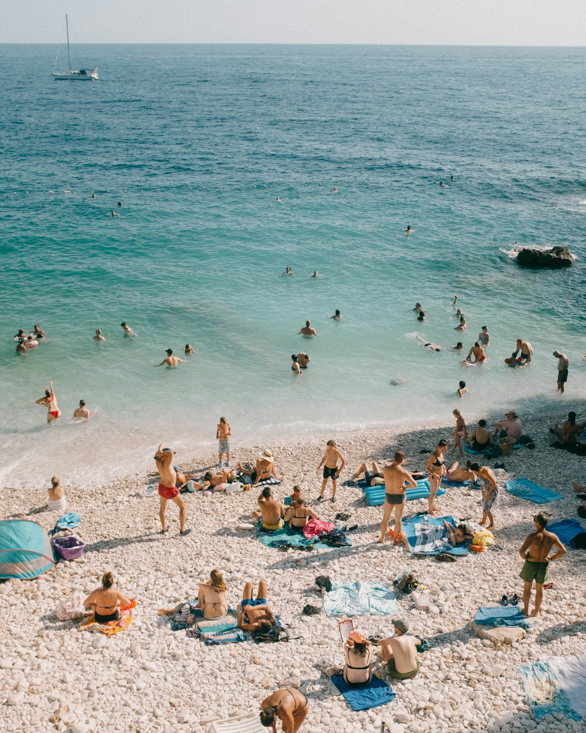 Turquoise shallows and a pebble beach seen from above