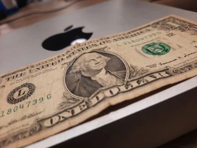 Close-up of a crisp US one-dollar bill highlighting George Washington's portrait and intricate green patterns.