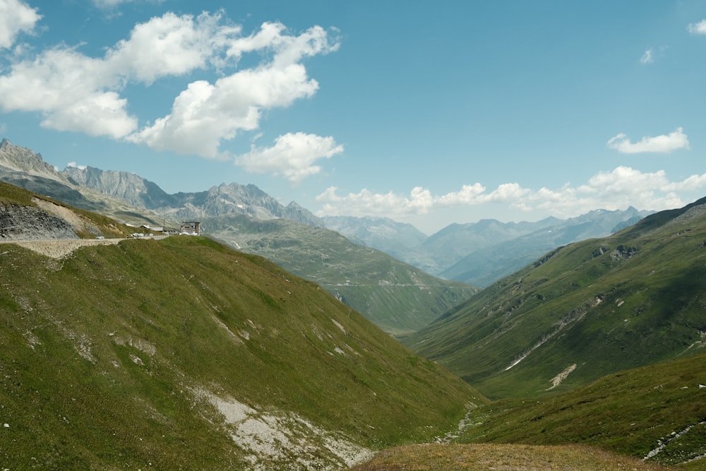 a valley with mountains in the background