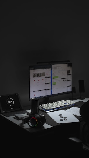 a desk with a laptop and a computer on it