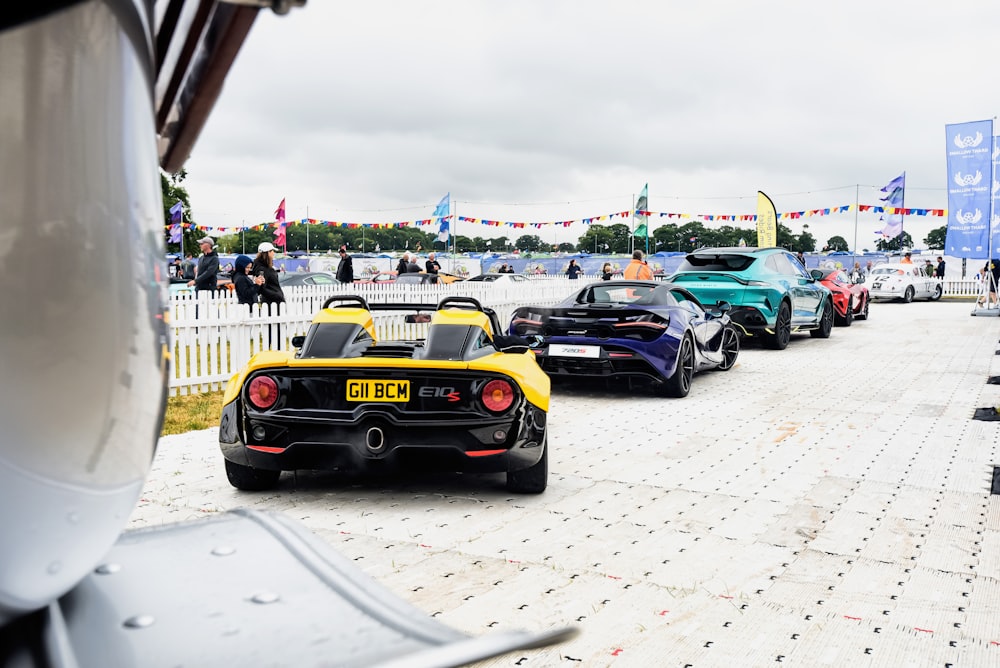 a group of race cars parked on a road