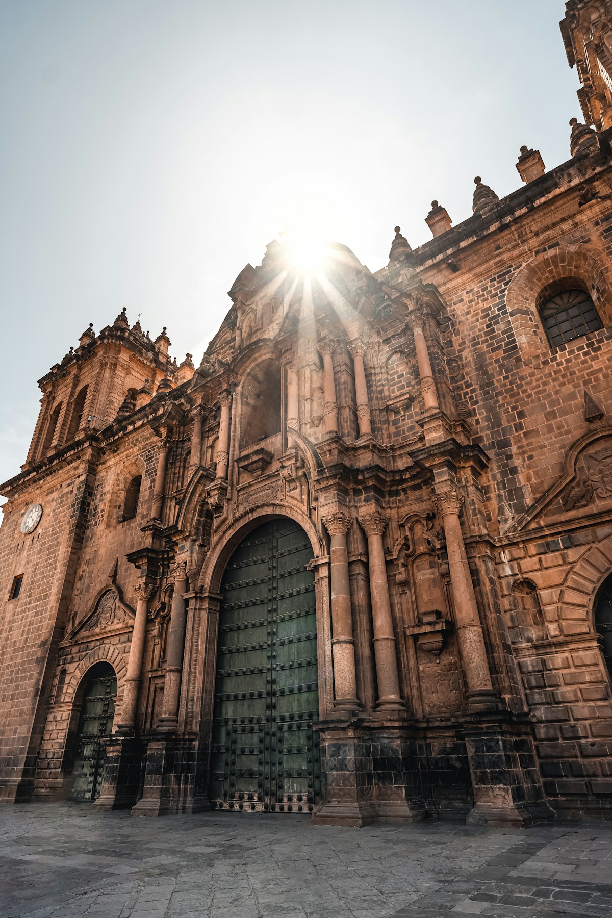 Cusco June — the cathedral facade bathed in golden sunlight in the clear dry-season air of the Plaza de Armas