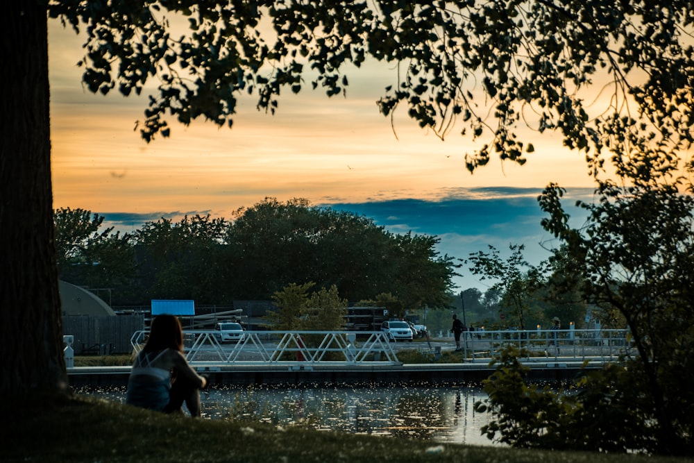 a person sitting on a bench by a lake