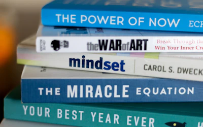 A stack of colorful ebooks with inspiring covers on productivity and personal growth.