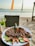 A vibrant plate of seafood with colorful garnishes served at a beachside restaurant.