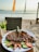 A vibrant plate of seafood with colorful garnishes served at a beachside restaurant.