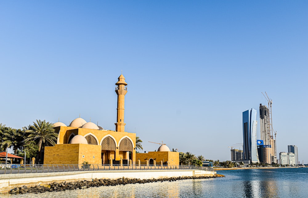 a building with a tower by the water