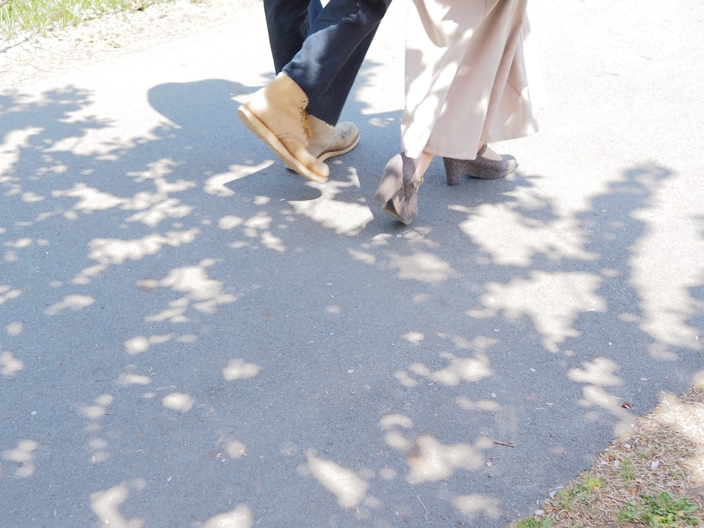 a pair of people's feet on a paved area