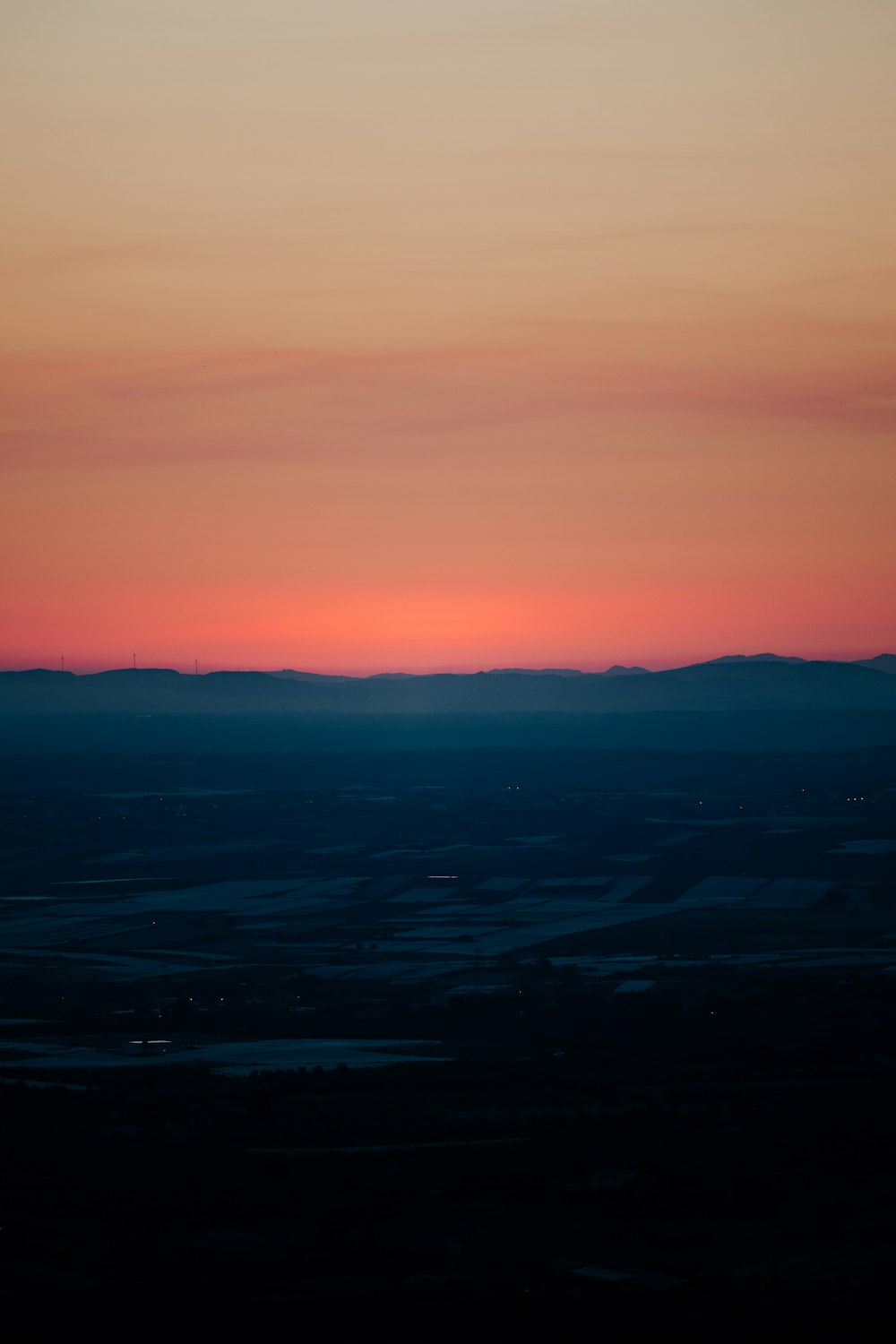 a landscape with a body of water in the distance