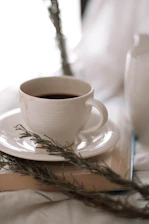 Soft illustration of a steaming coffee cup beside a small plant, evoking calm and connection.