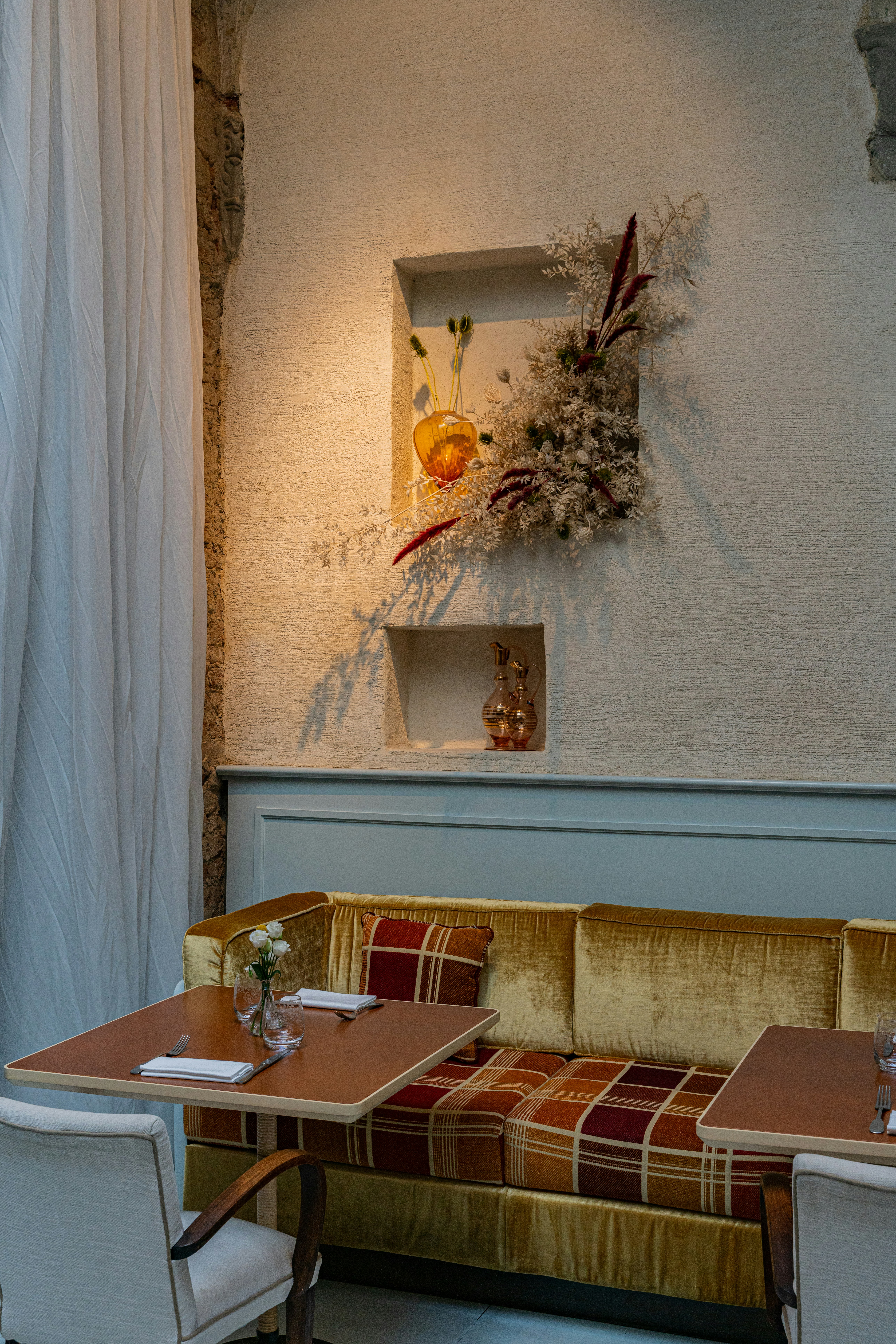 a room with a couch and a table with a lamp on it