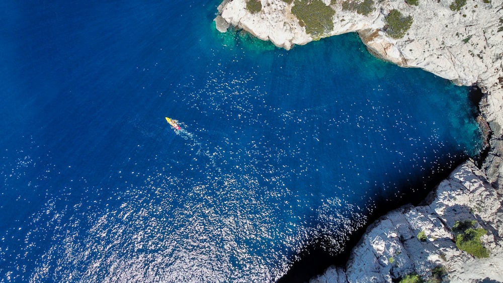 a body of water with a rocky shore and a beach