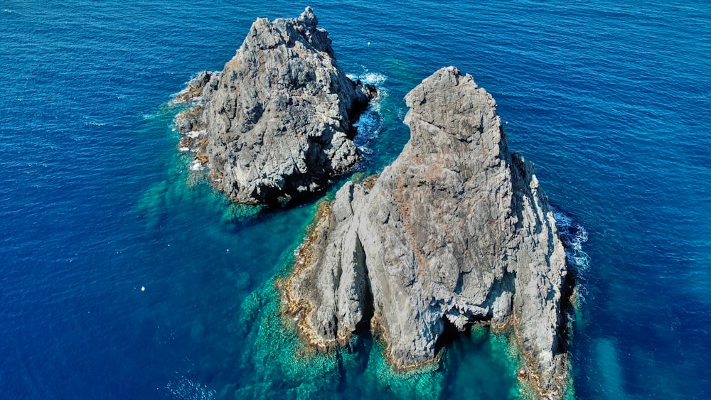 a group of large rocks in the water