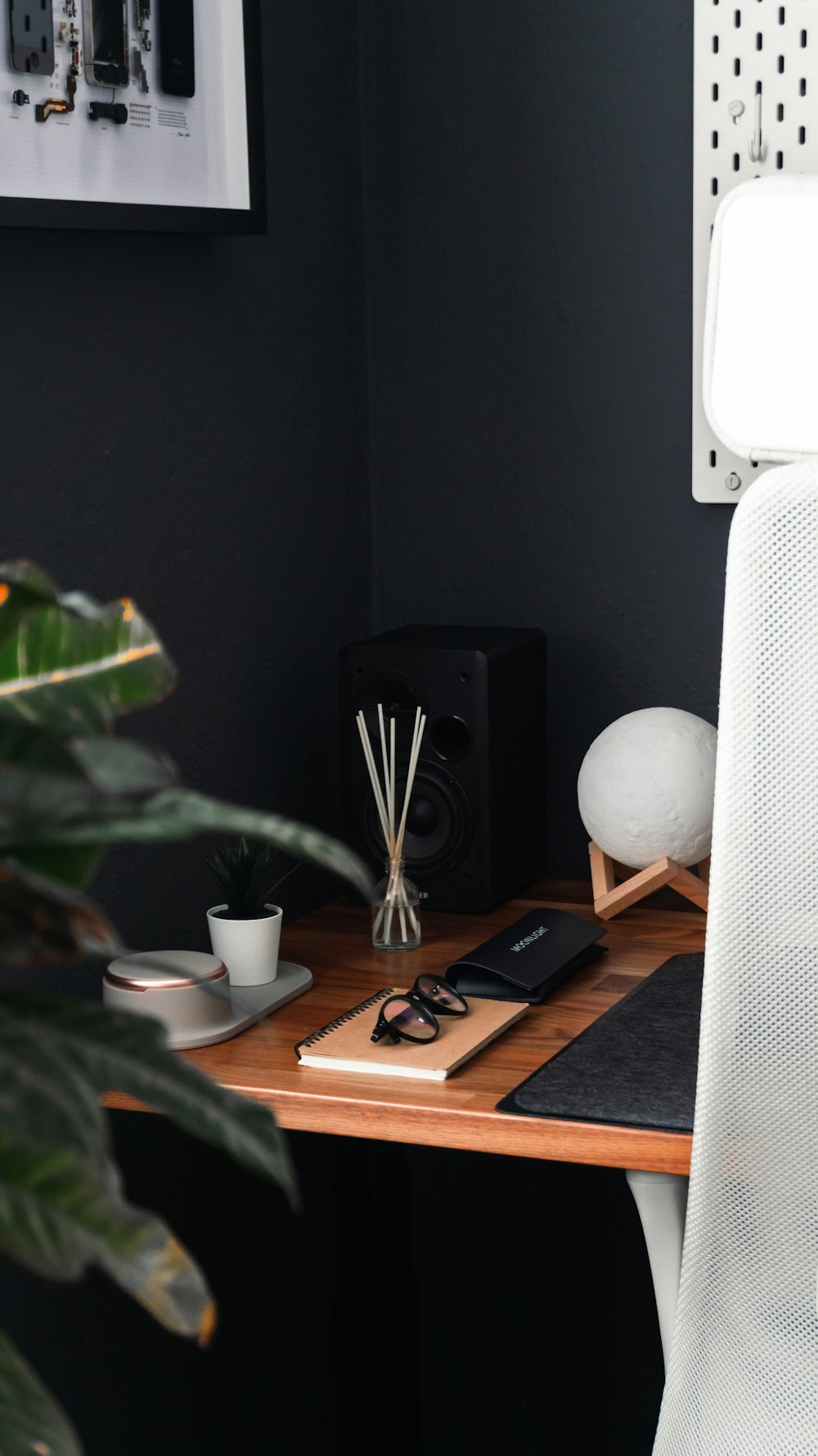 a desk with a phone and glasses