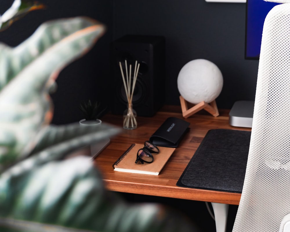 a table with a phone and a lamp on it