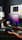 Professional cleaner wiping a modern office desk with purple accents in the background.