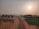 A serene beach scene with massage tables lined up facing the sea at sunset
