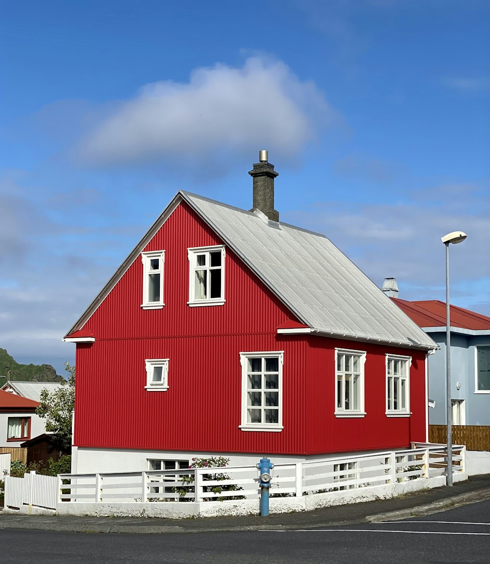 a red barn with a white picket fence