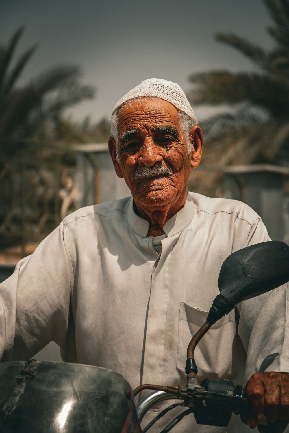 a man with a white head covering and a microphone