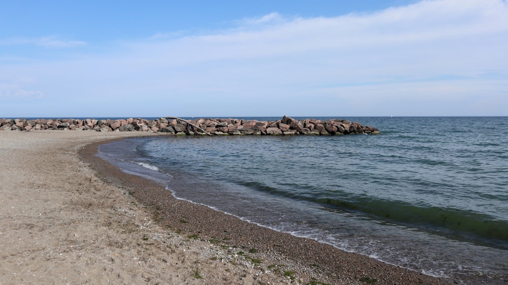 a beach with rocks and water