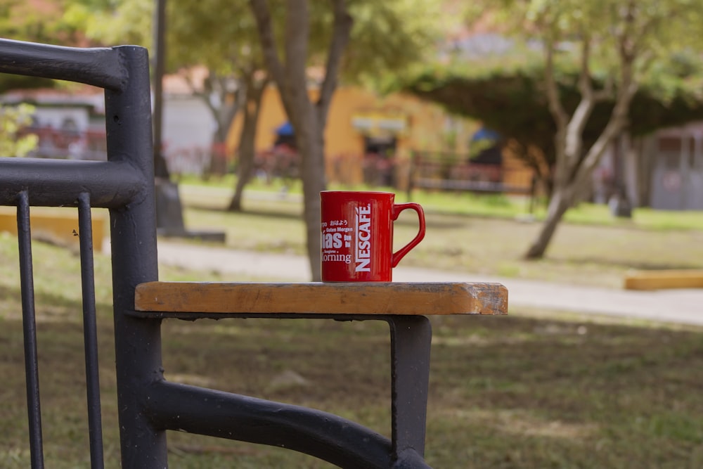 a red can on a bench
