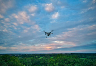 Drone flying over a lush green field capturing multispectral images.