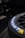 A close-up view of a Michelin tire with part of the brand logo and name clearly visible. The tire appears to be attached to a wheel with visible spokes, set against a dark and slightly blurred background.