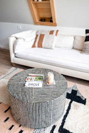 A modern living room showcasing a blend of pillows and area rugs.