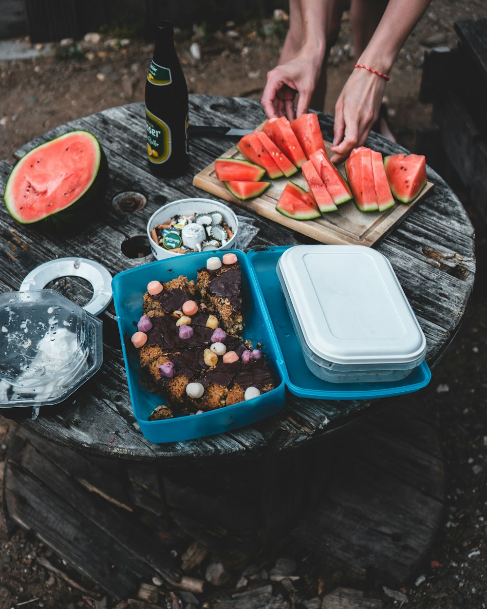 a person cutting a fruit cake