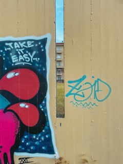 A playful sticker of a tiny car with a speech bubble saying 'Take it easy,' rendered in soft pastel tones.